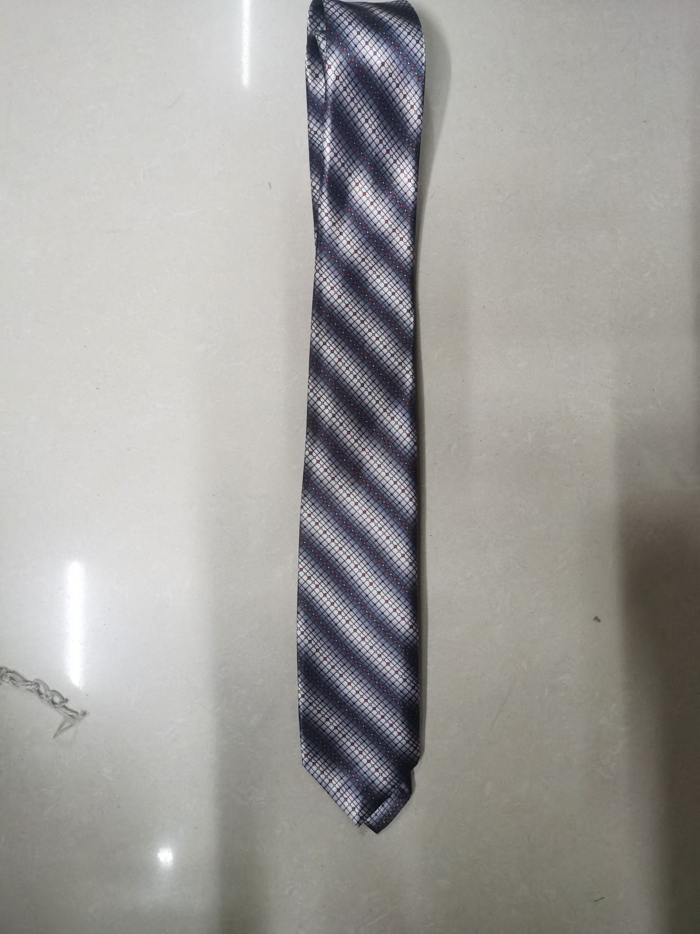 A grey tie with chemical fiber transfer printing details Picture