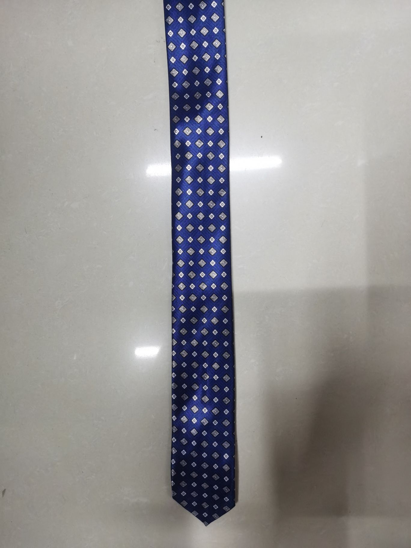 A grey tie with chemical fiber transfer printing