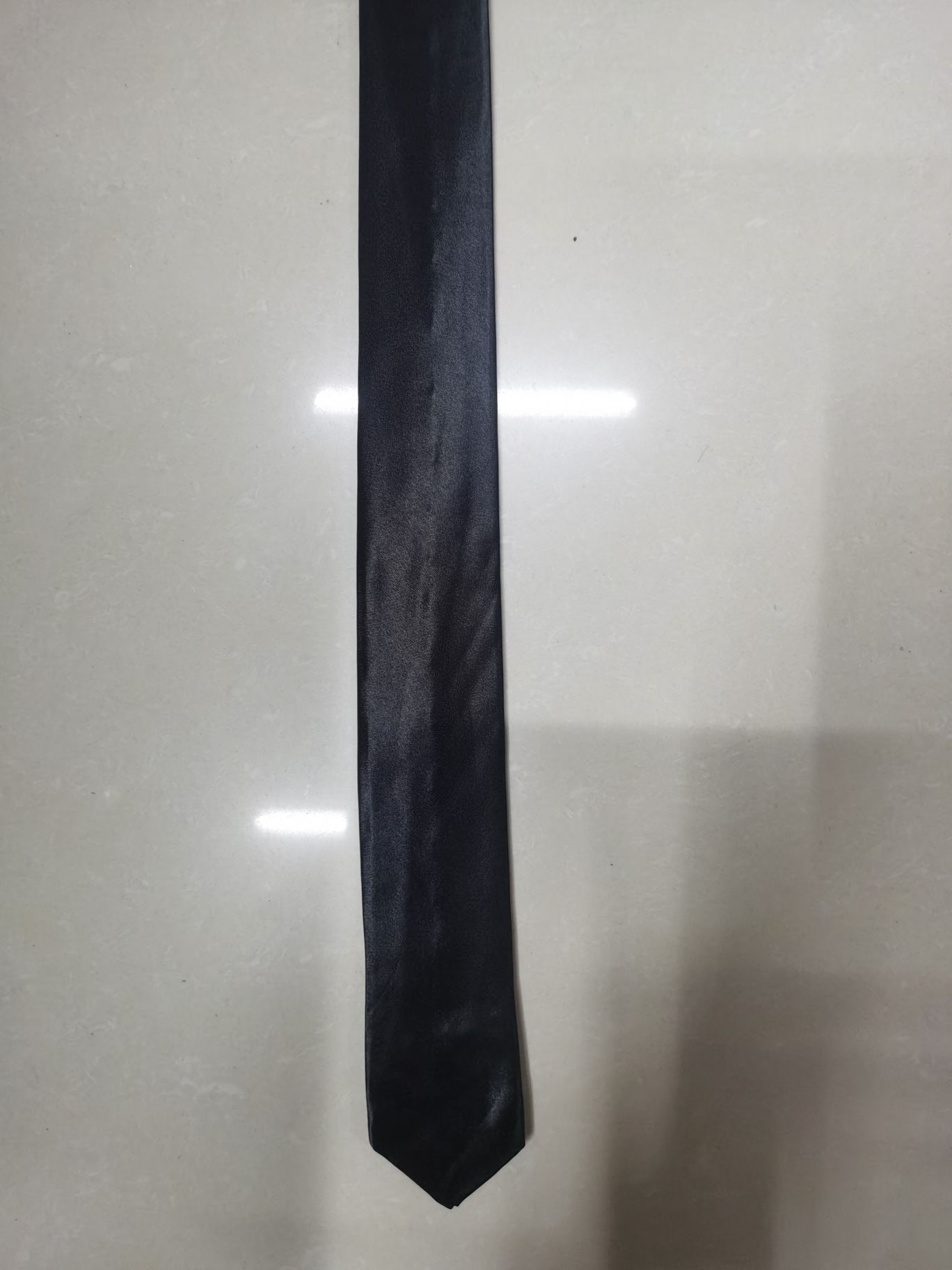 A grey tie dyed with chemical fibers details Picture