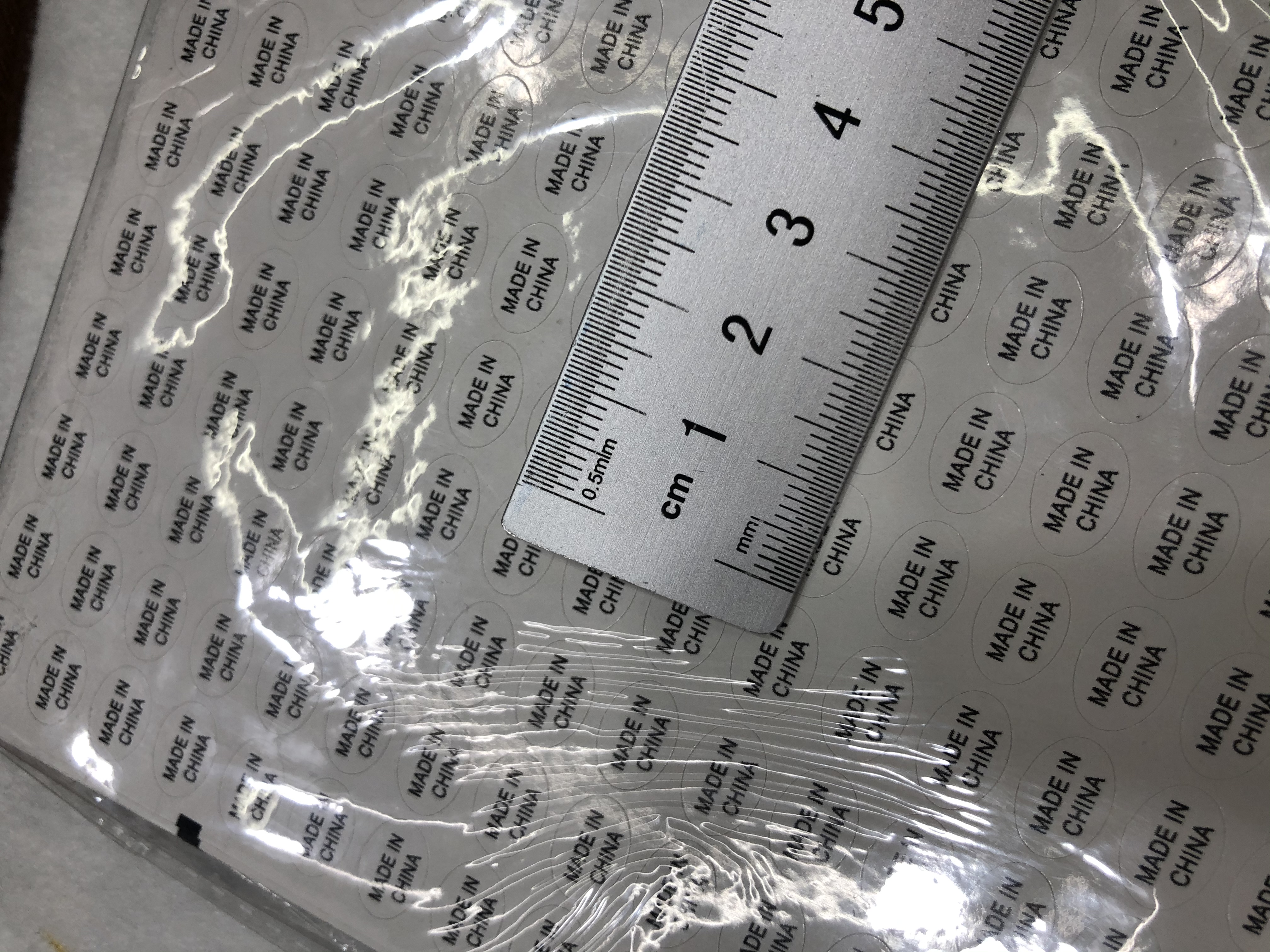 1.1*0.8白底黑字圆形不干胶印刷中国制造标签详情图2