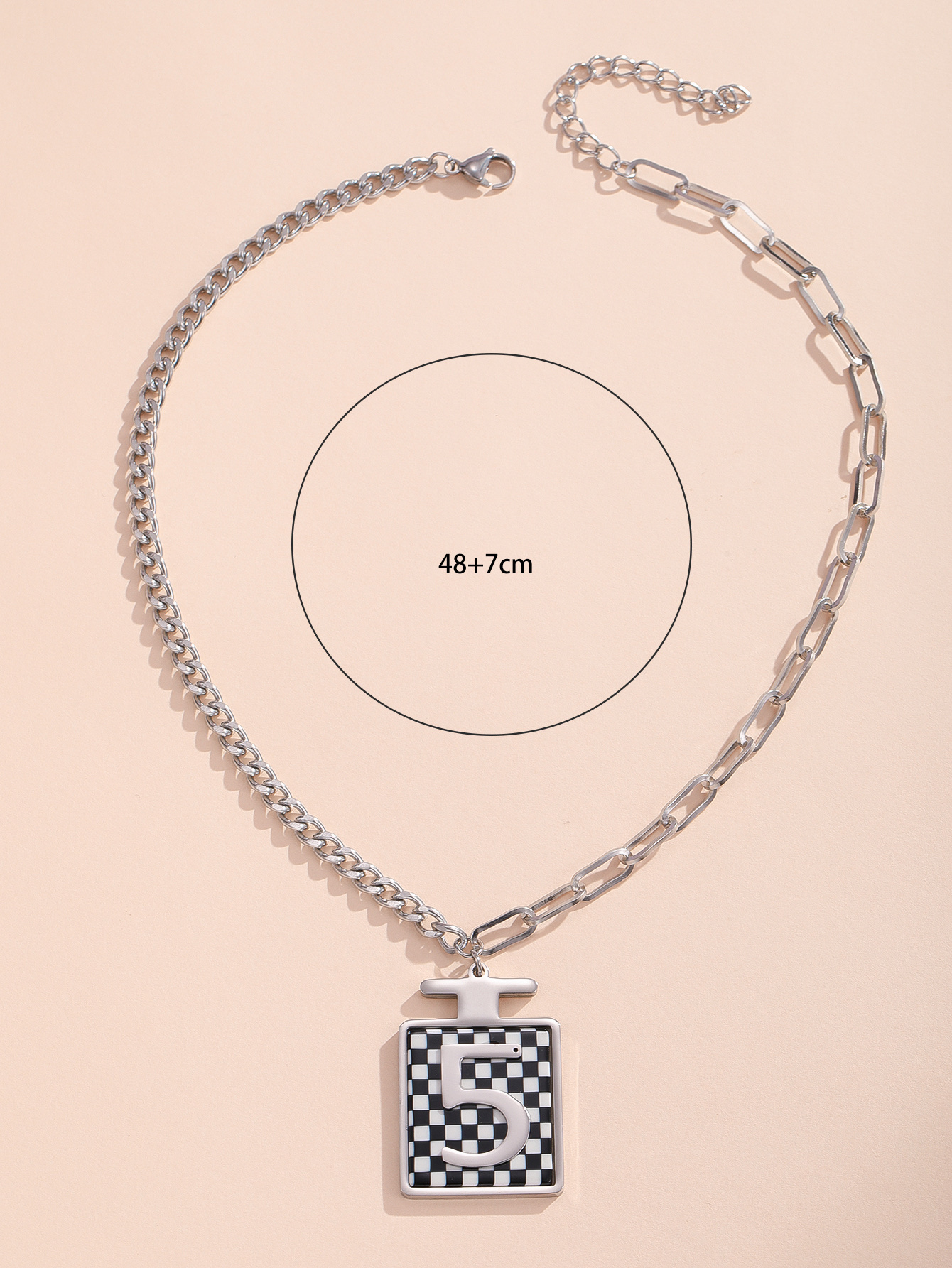 A black and white B-shaped stainless steel necklace in a perfume bottle details Picture