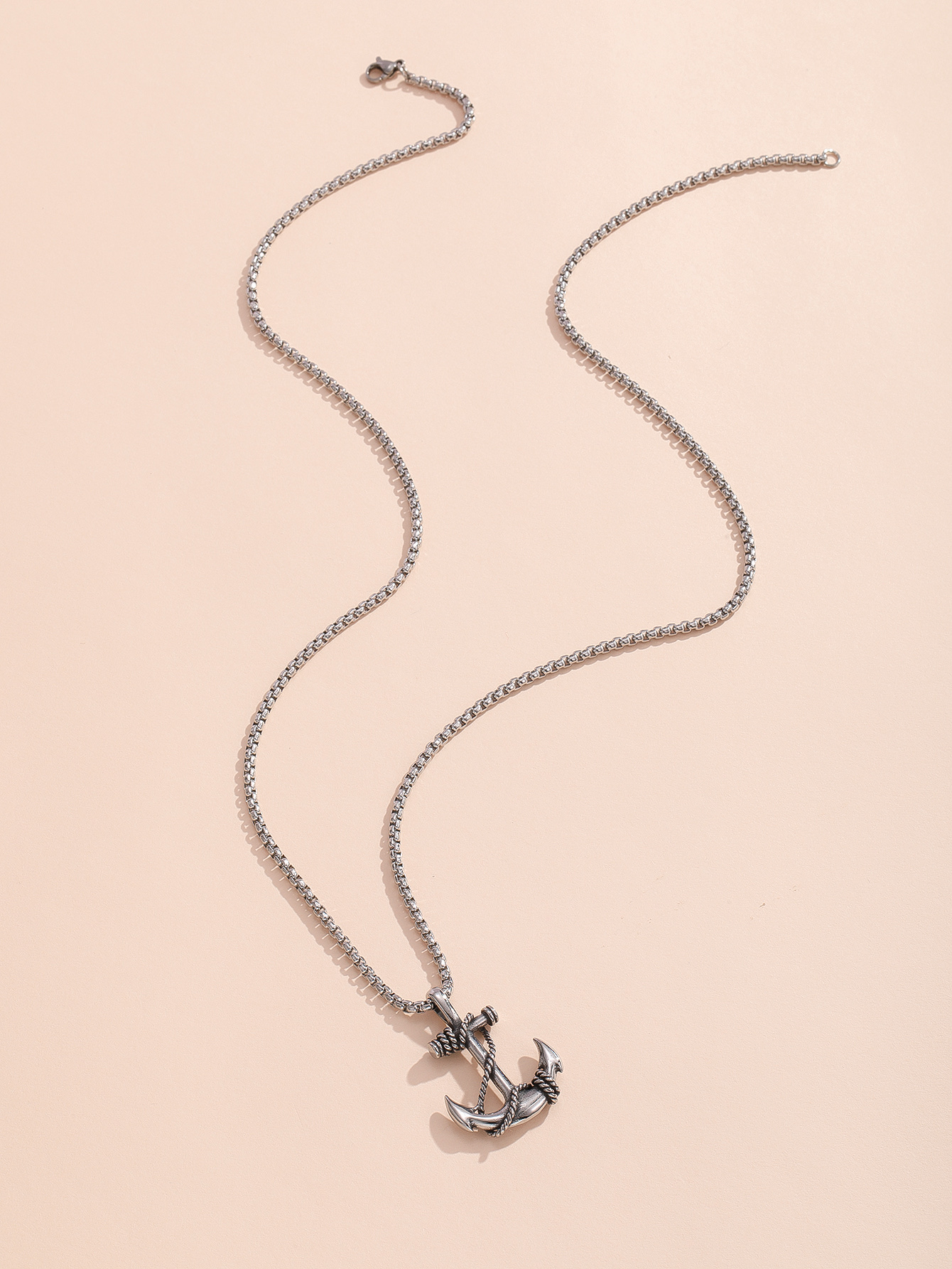 A stainless steel pendant necklace with pirate ship anchor