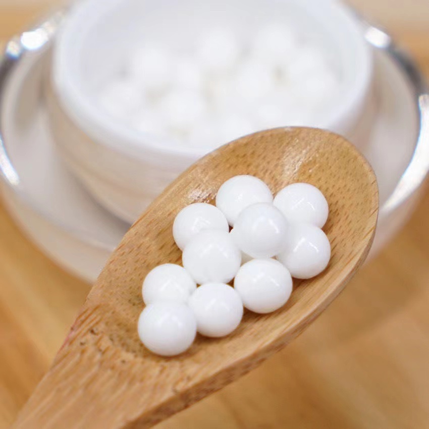 Woman applying Midseido cream during her morning routine with sunlight streaming through window