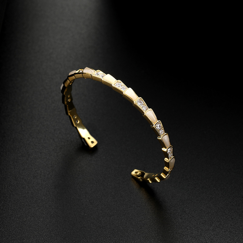 This is a trendy shell snake bone fashion bracelet with an open cat's eye detail image 4