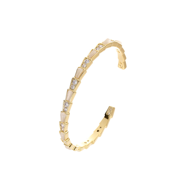 This is a trendy shell snake bone fashion bracelet with an open cat's eye detail image 5