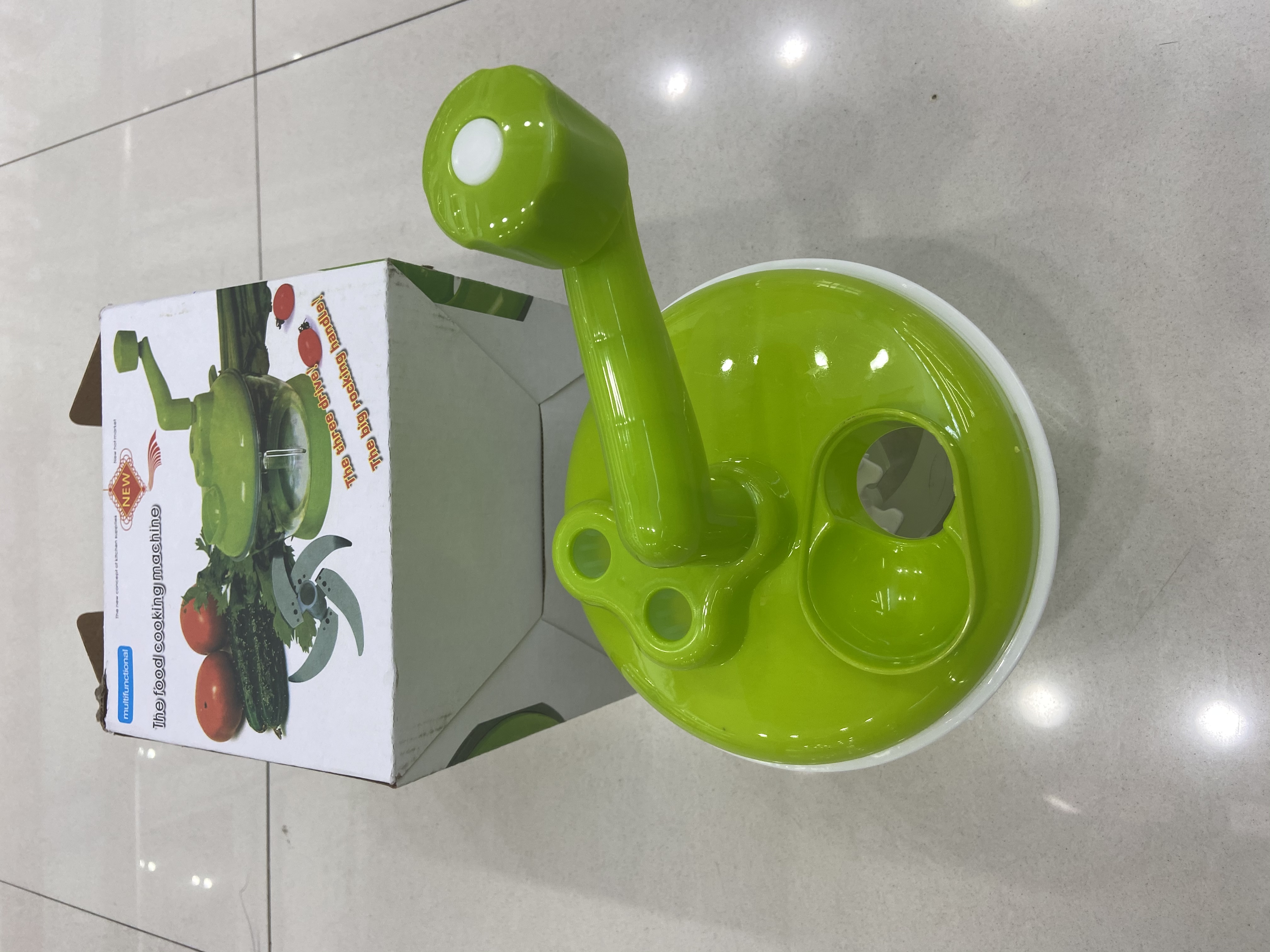 Green hand-cranked vegetable cutter
