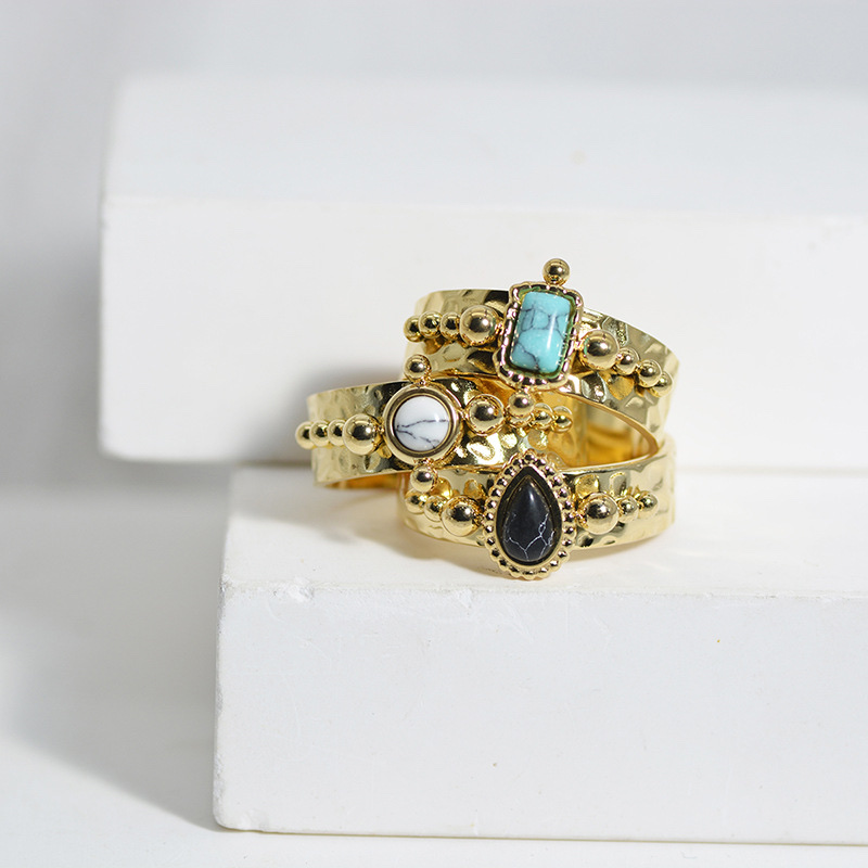 A French retro women's ring with a concave-convex texture, a stainless steel ring set with teardrop-shaped black turquoise and titanium steel plated with 14k gold Item Picture
