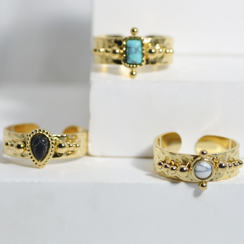 A French retro women's ring with a concave-convex texture, a stainless steel ring set with teardrop-shaped black turquoise and titanium steel plated with 14k gold Application Scenario