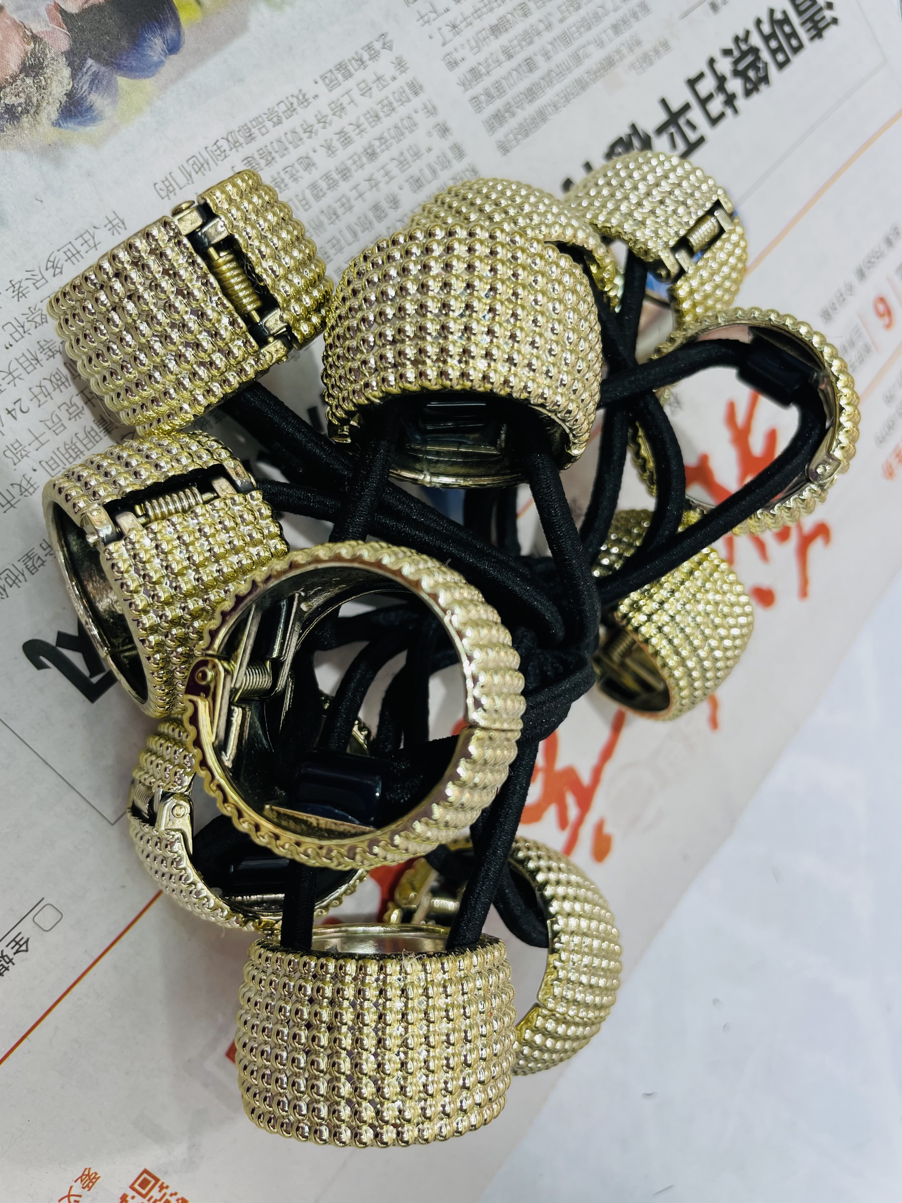 The ponytail is decorated in gold and silver