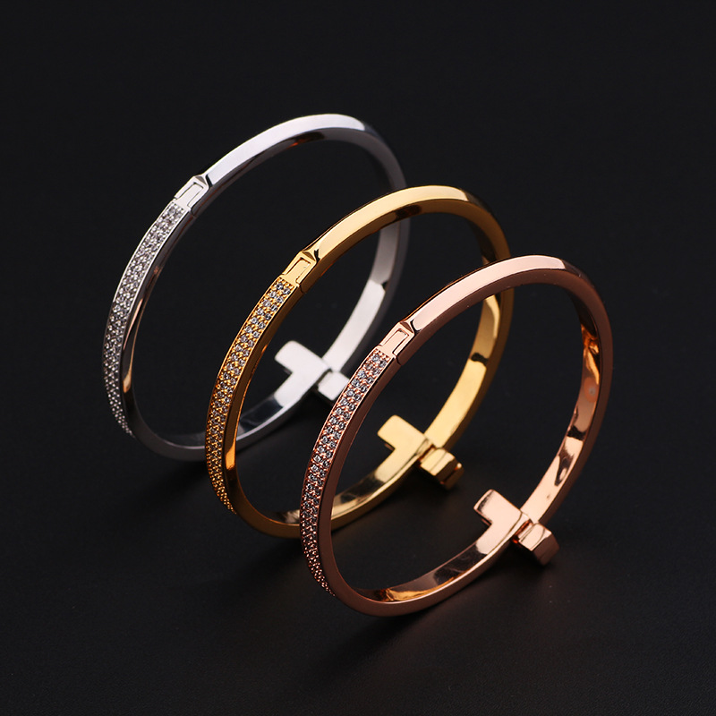 Creative gold-plated semi-inlaid double T bracelet, European and American fashion, versatile, light luxury women's style, slightly inlaid zircon wide version bracelet wholesale detail image 6