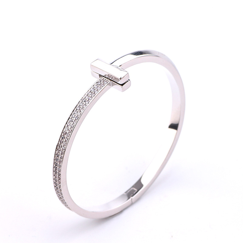 Creative gold-plated semi-inlaid double T bracelet, European and American fashion, versatile, light luxury women's style, slightly inlaid zircon wide version bracelet wholesale detail image 2