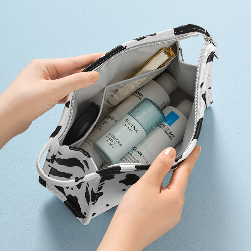 Waterproof PU cosmetic bag, InS-style cow print hand-held cosmetic bag, travel and outing milk print cosmetic storage bag details Picture