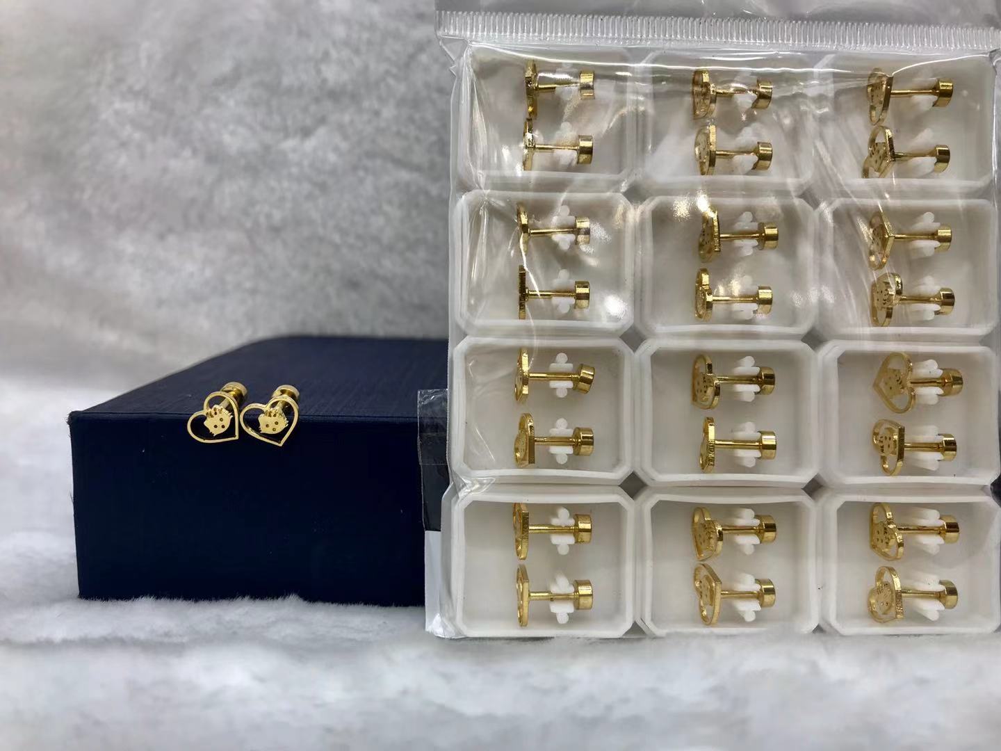 Titanium steel golden hollowed-out cat ear studs