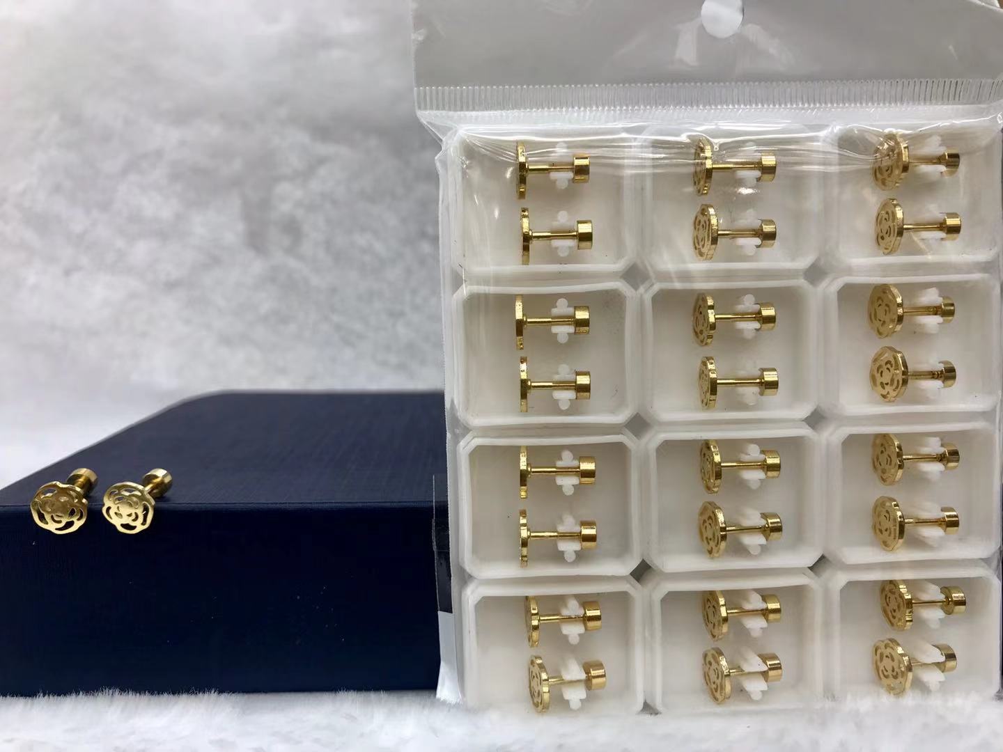 Titanium steel golden hollowed-out rose ear studs