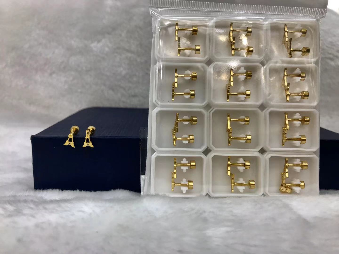 Titanium steel golden hollowed-out pyramid ear studs