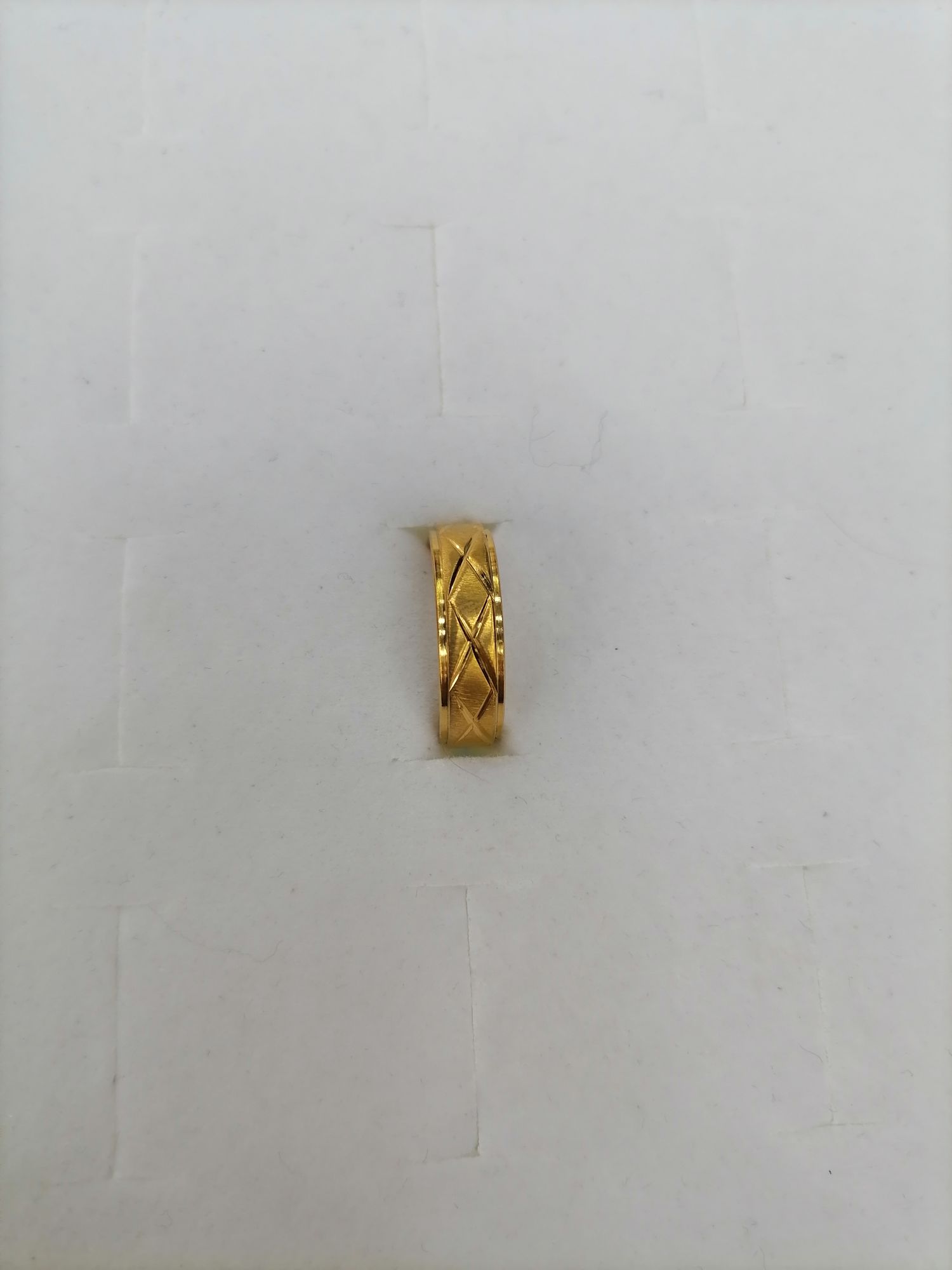 A titanium steel gold semi-ground printed cross outer layer ring