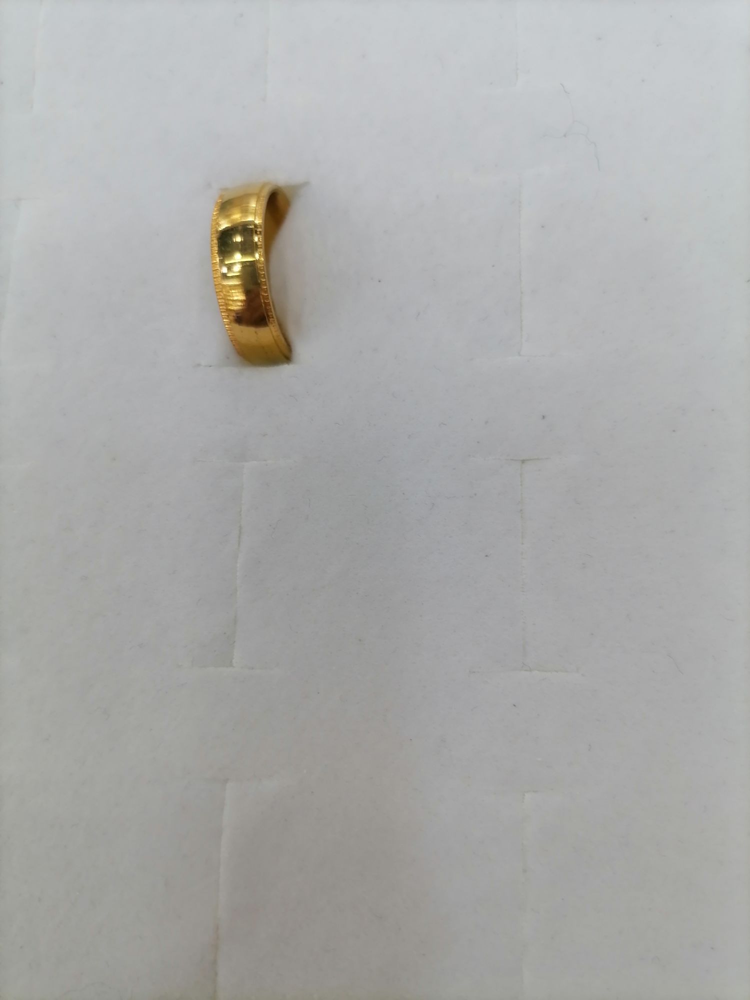 A titanium steel gold mid-wide ring with fine printed lines on the outside details Picture