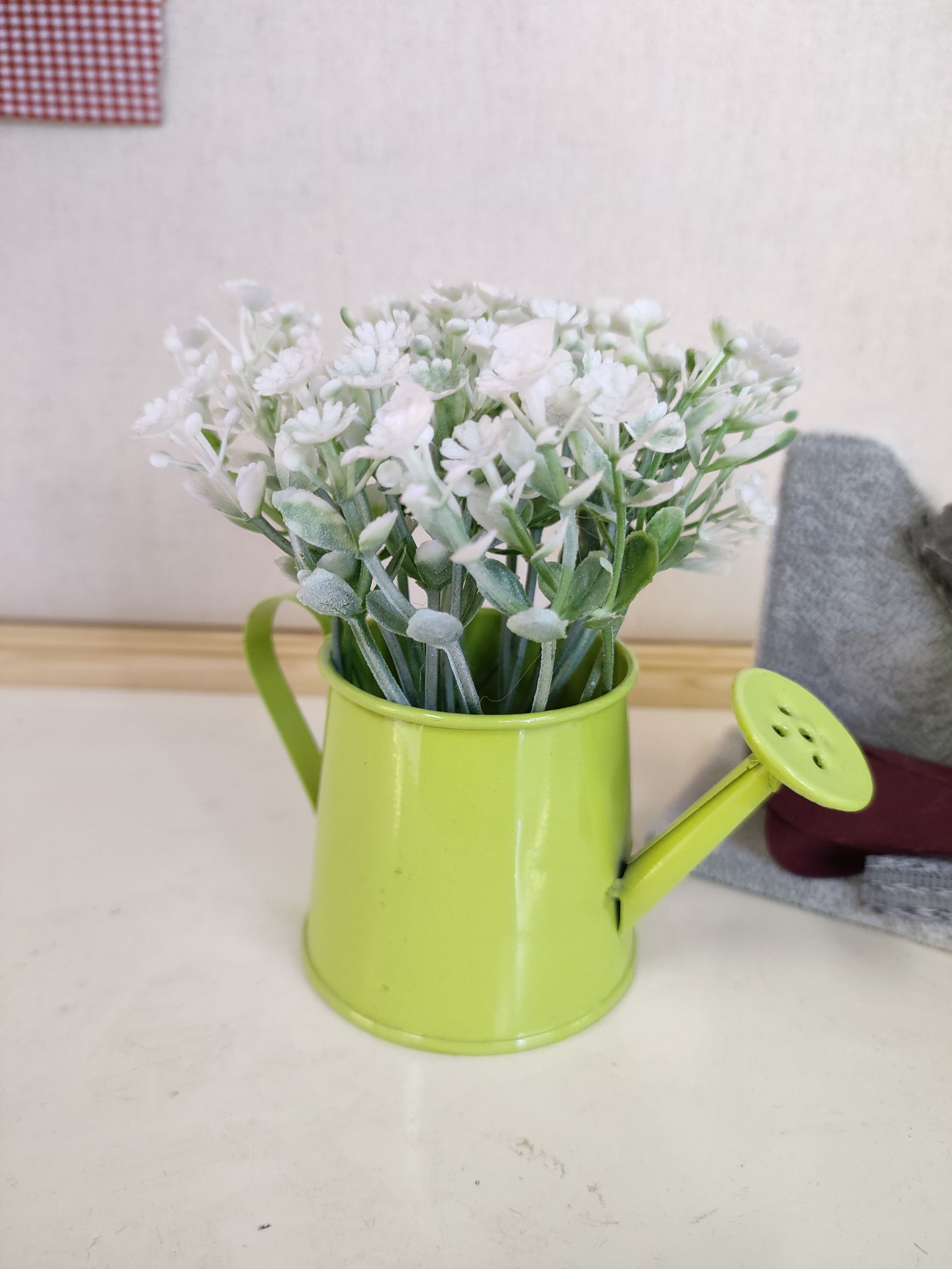 A small water spray in an iron bucket for artificial plant bonsai