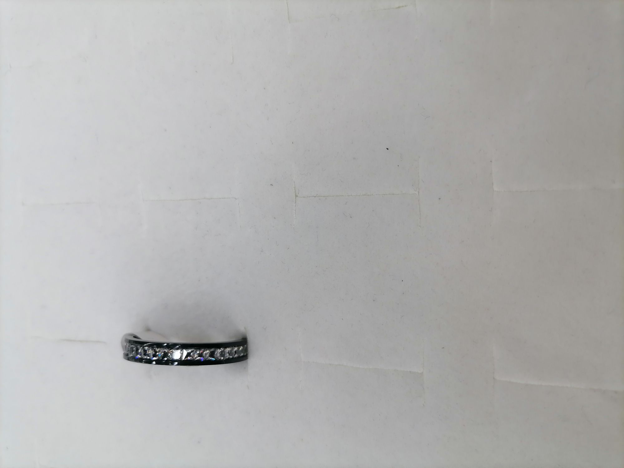 A black titanium steel ring with a row of diamonds