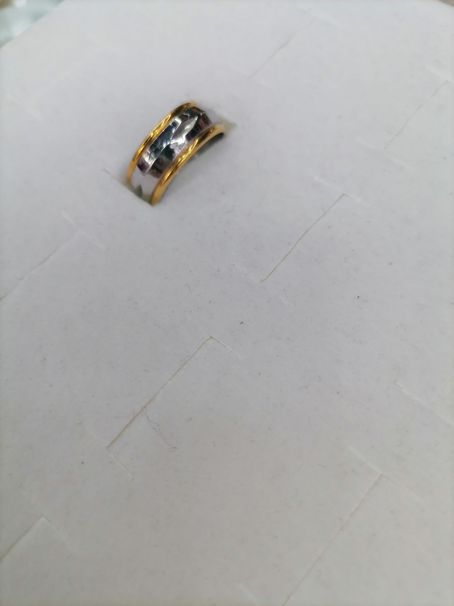 A circular ring with a titanium steel gradient gold embossed surface