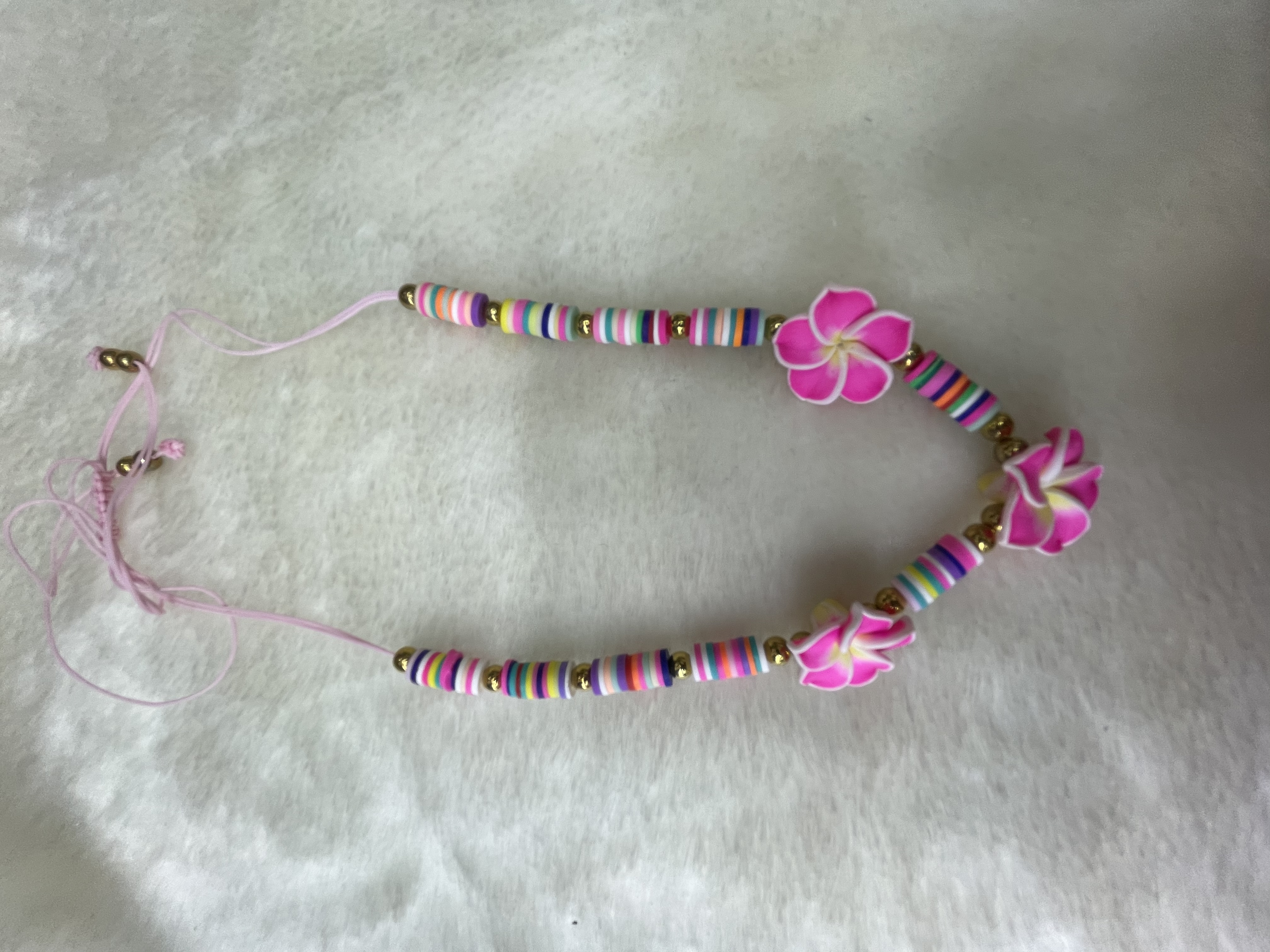 A string of soft ceramic pieces and soft ceramic flower necklace details Picture