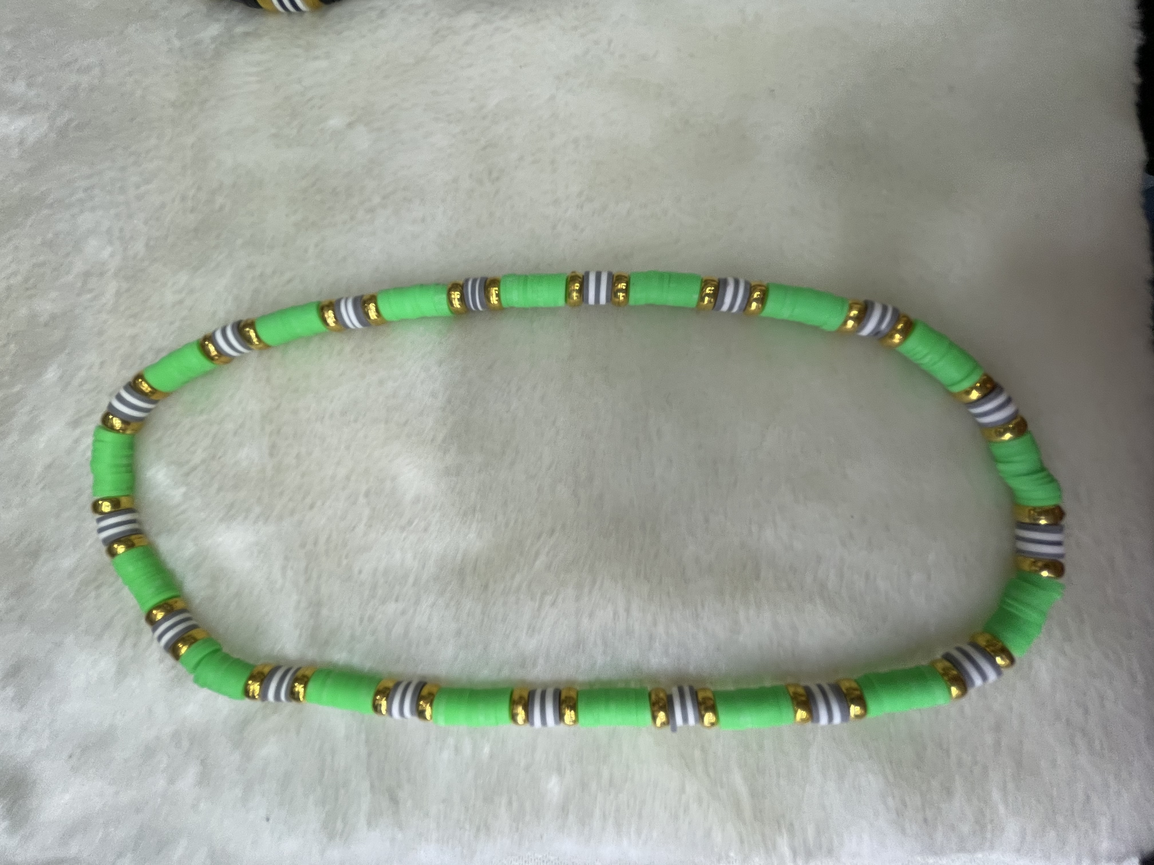 A necklace of medium green soft ceramic tiles and gold-plated flat beads Specification image