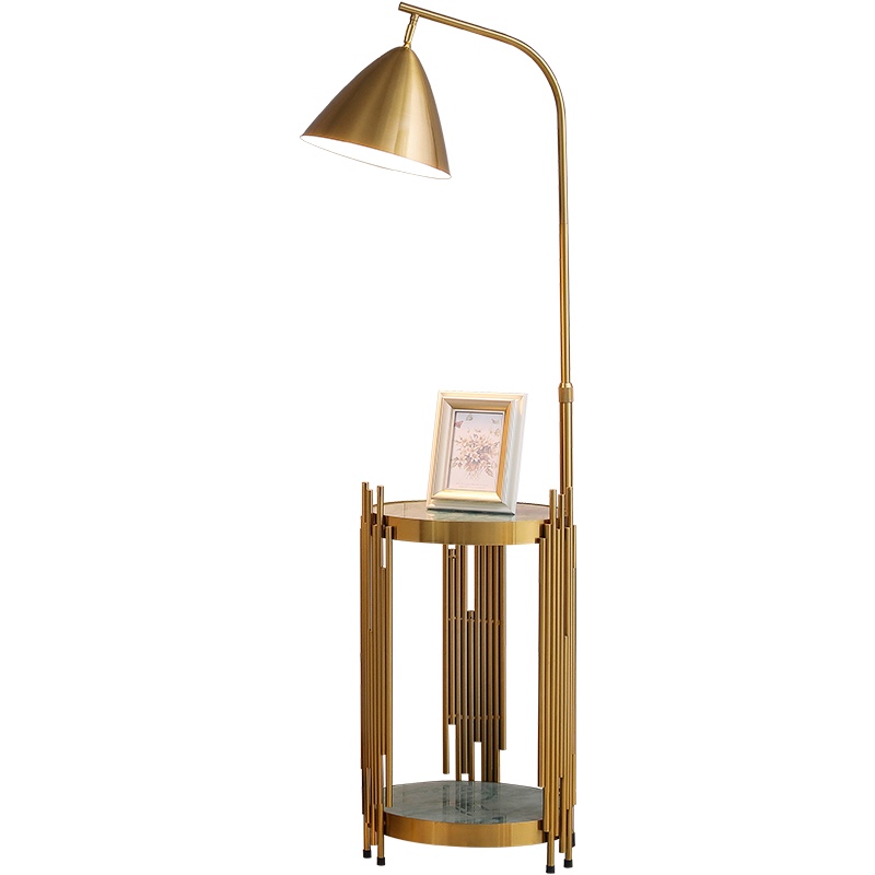 A golden and black table with a ground lamp