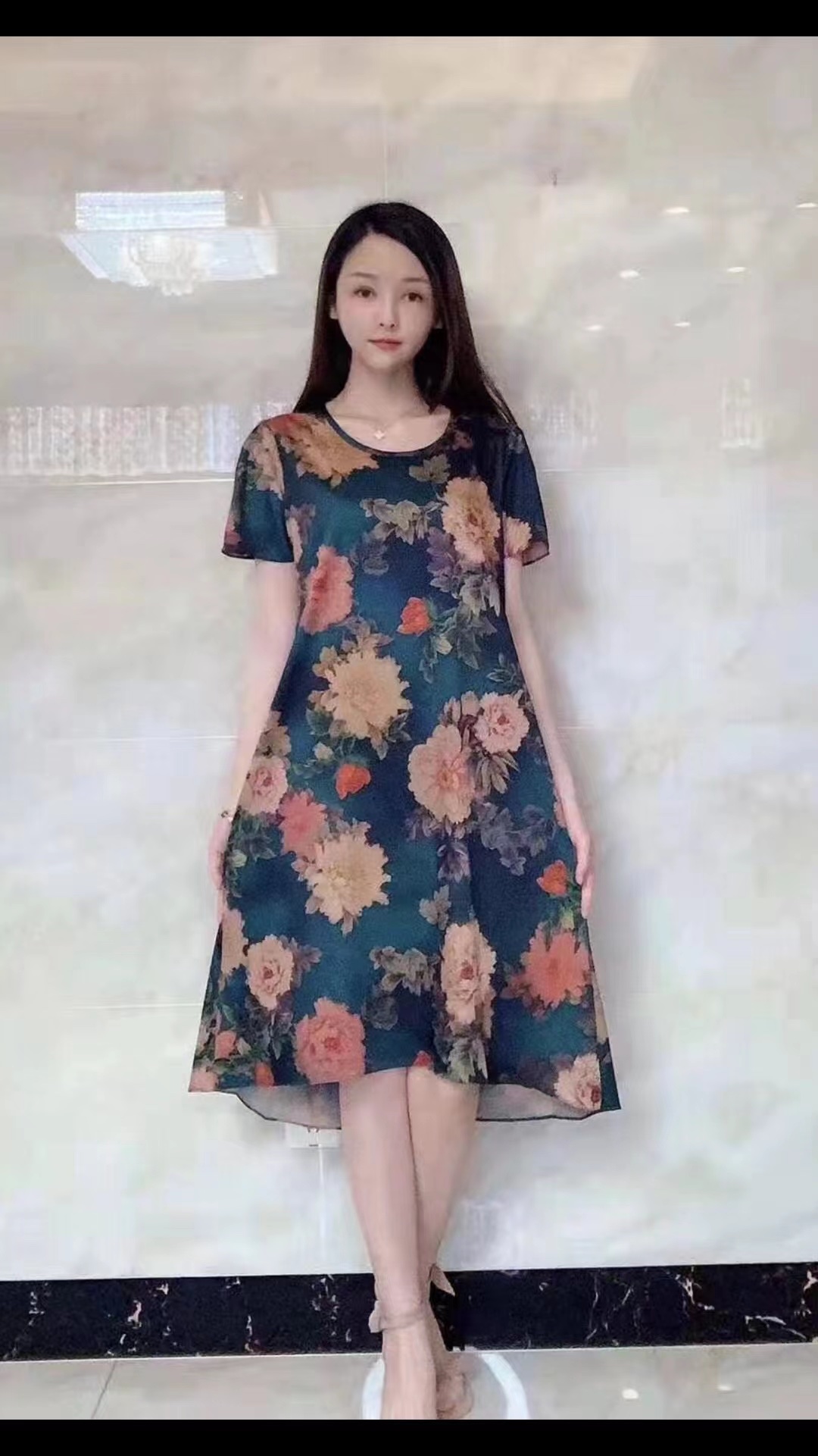A silk-like dress with large floral patterns in blue and green