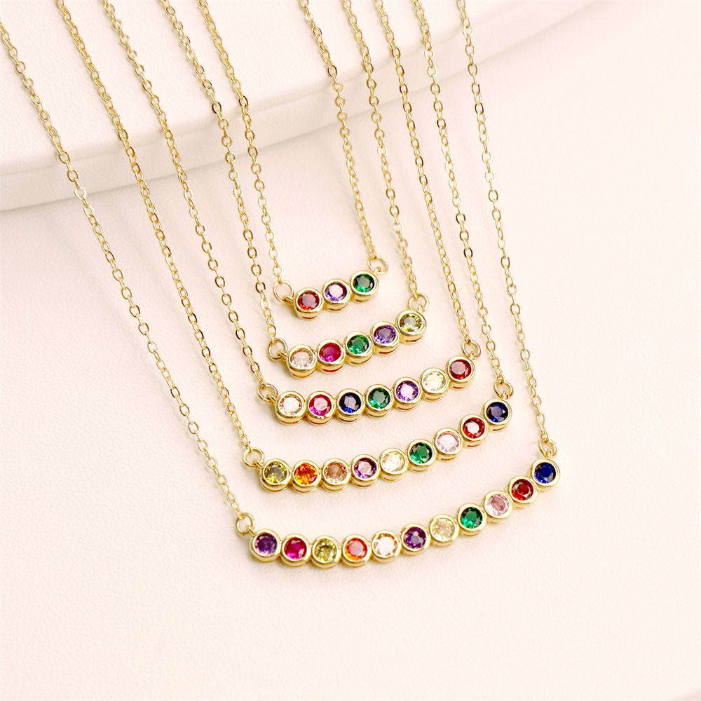A fashionable lady's necklace features a row of slightly inlaid round zircon pendants and a collarbone chain. It is a niche design and elegant necklace accessory