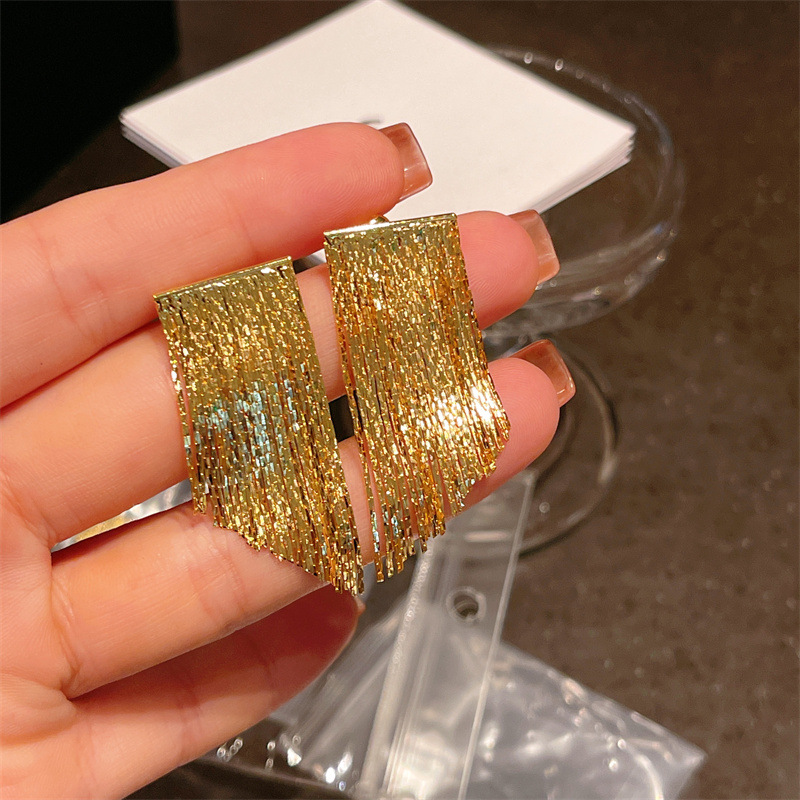 Fashionable and high-end geometric light plate flowing year arc-shaped tassel earrings, simple design sense earrings