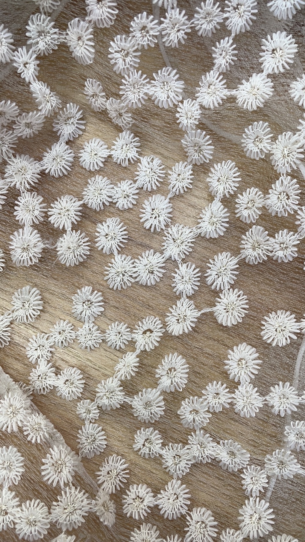 The entire lace is embroidered with golden thread chrysanthemums