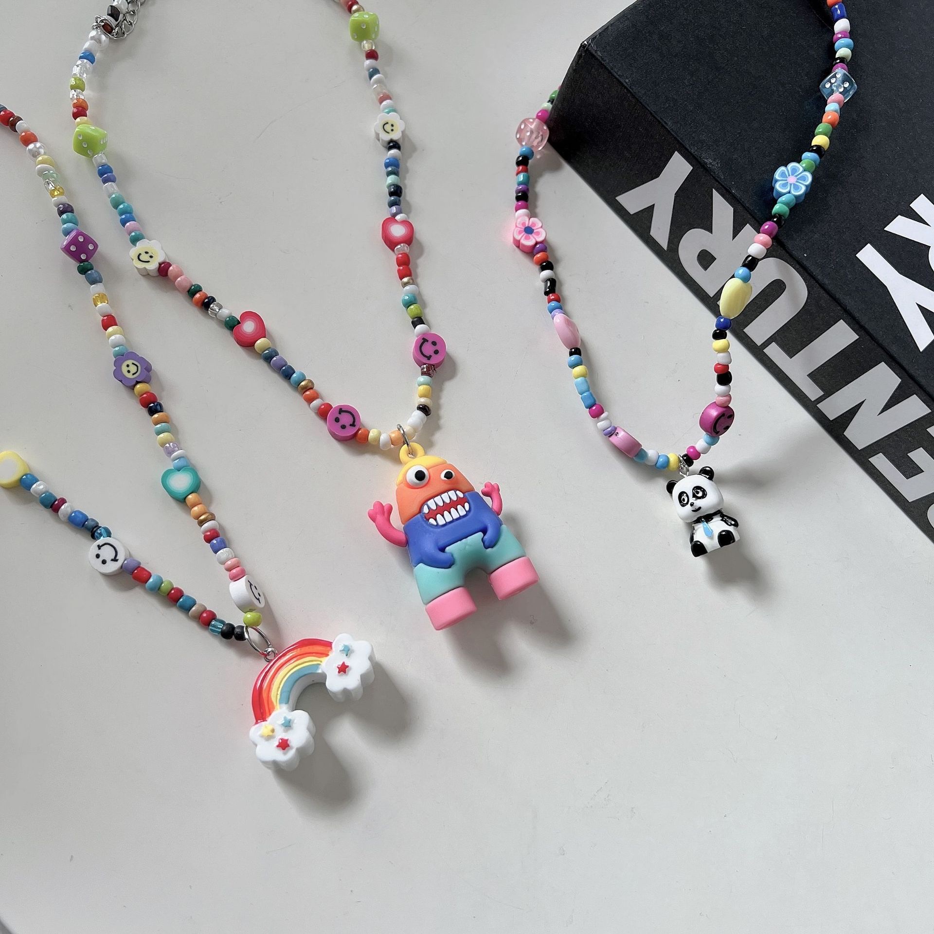 Internet-famous best-selling accessories: rice bead necklace, hip-hop dice smiley face, collarbone chain, female rainbow monster pendant, Korean version jewelry, Yuzu ear Application Scenario
