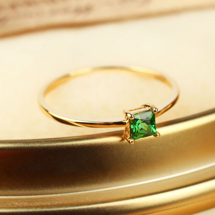 A fashionable square emerald engagement ring slightly studded with diamonds for a simple wedding details Picture