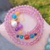 A woman wrapped a strawberry crystal bracelet three times details Picture