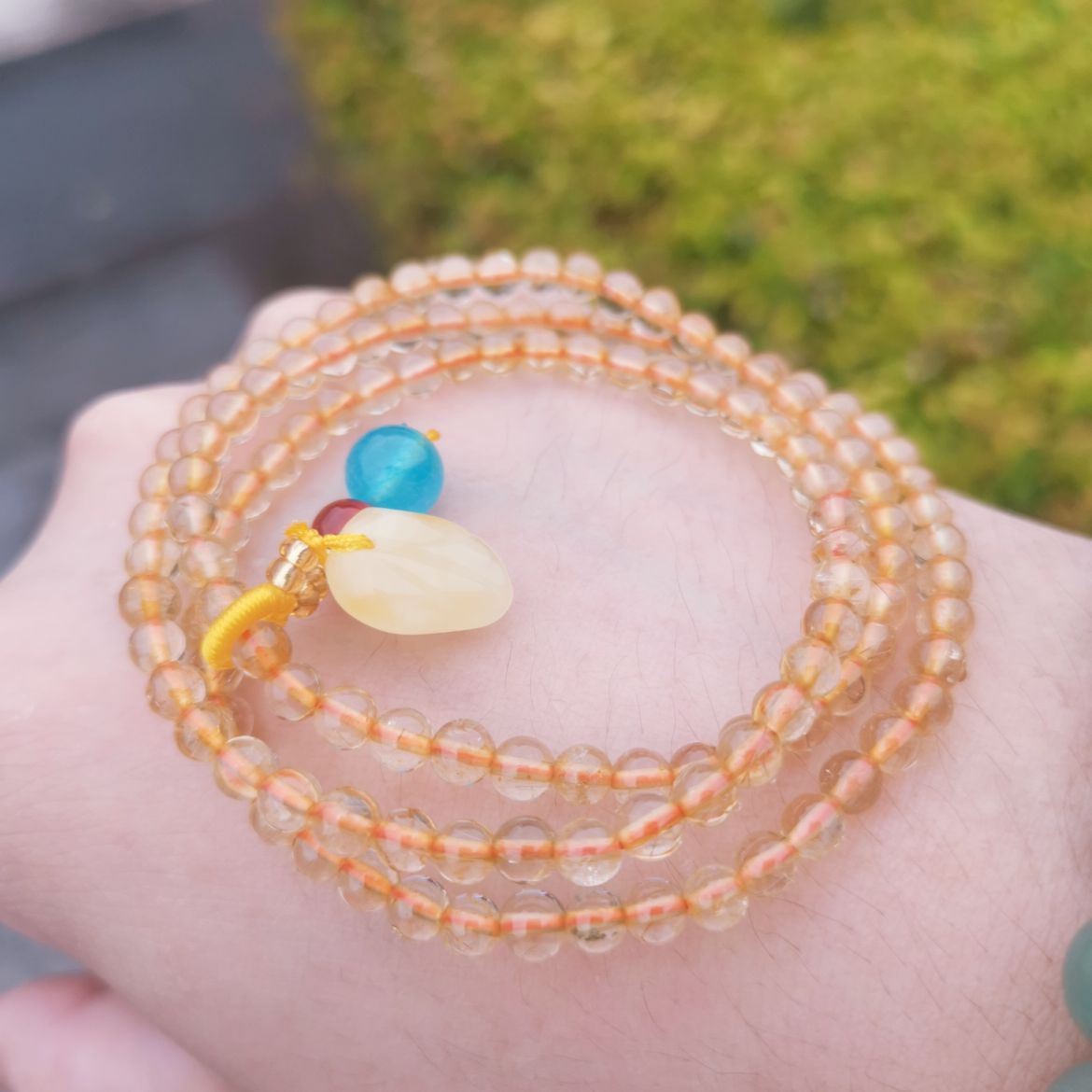 A women's bracelet wrapped with yellow crystal three times