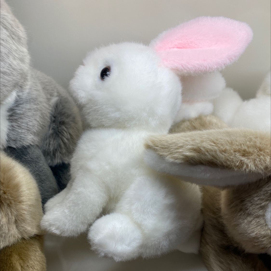 Sitting on a rabbit plush 1