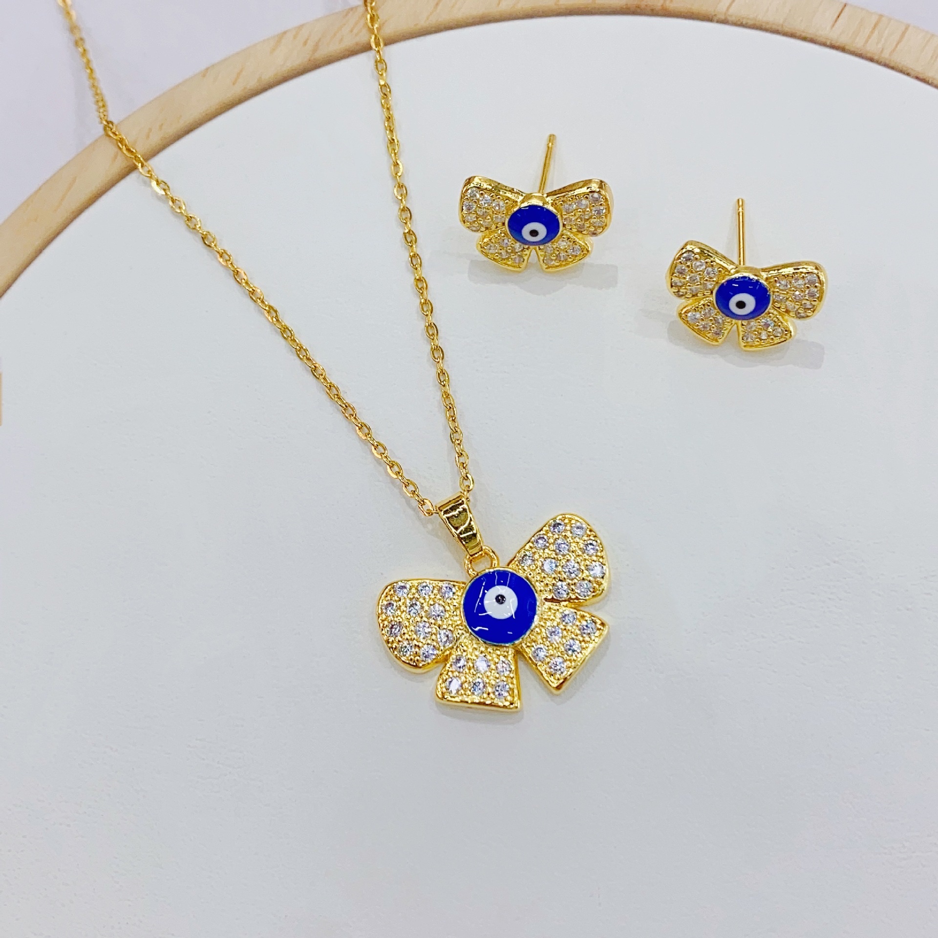 European and American cross-border InS-style Devil's Eye stud necklace set pendant, copper 18K butterfly knot eye necklace earrings Application Scenario