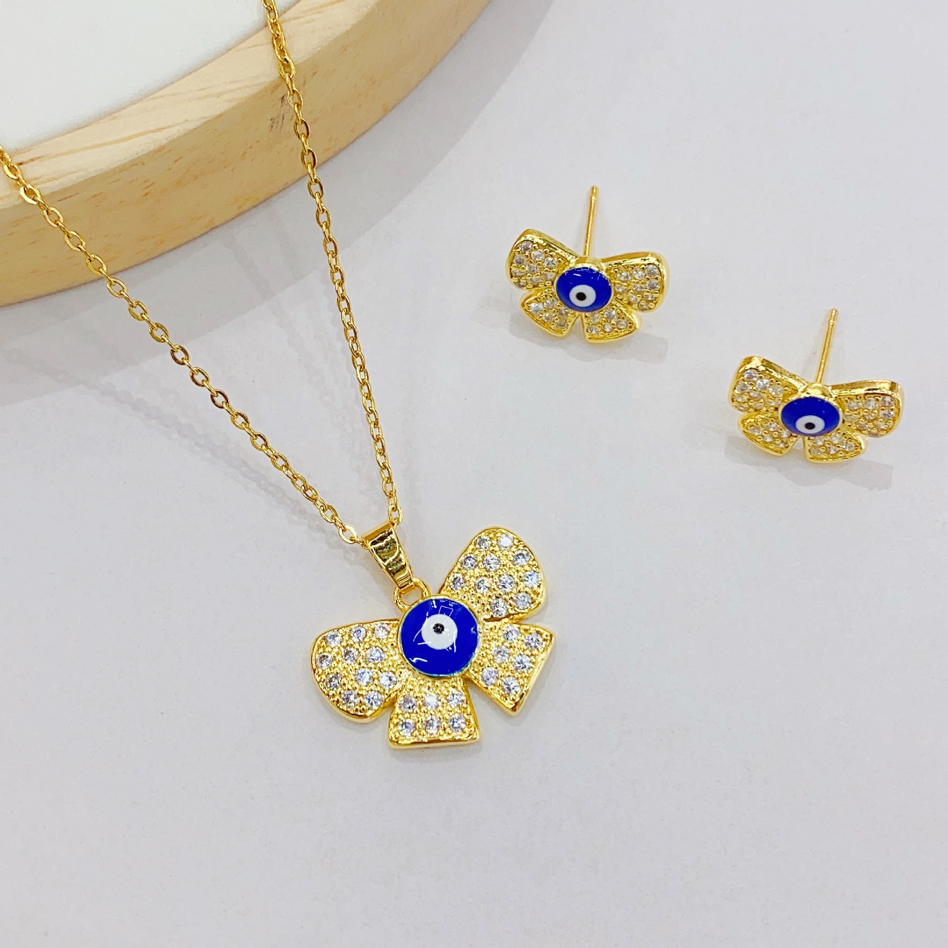 European and American cross-border InS-style Devil's Eye stud necklace set pendant, copper 18K butterfly knot eye necklace earrings Specification image
