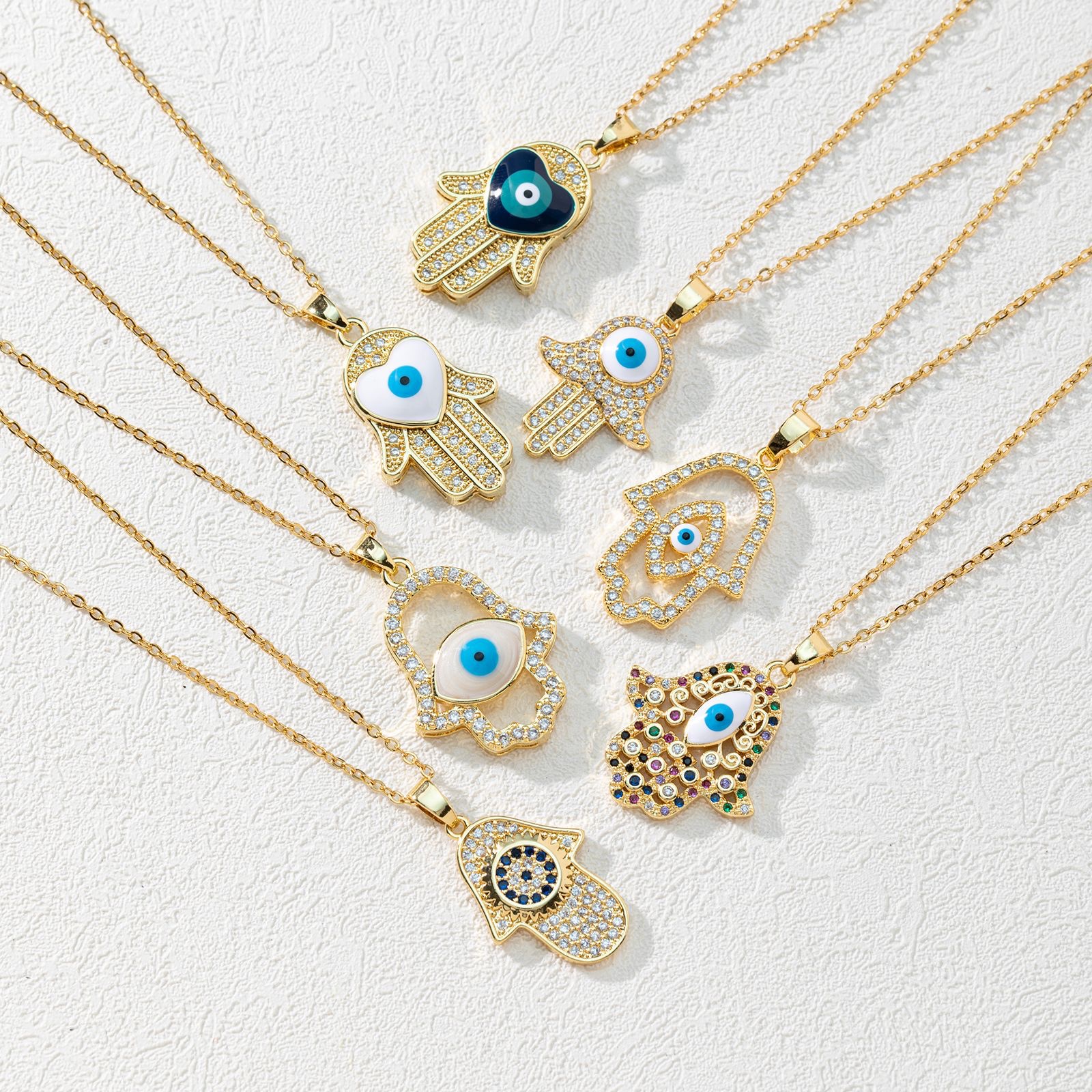 A new European and American fashion trend copper zircon Devil's eye palm necklace pendant with micro-inlaid electroplated real gold sweater chain