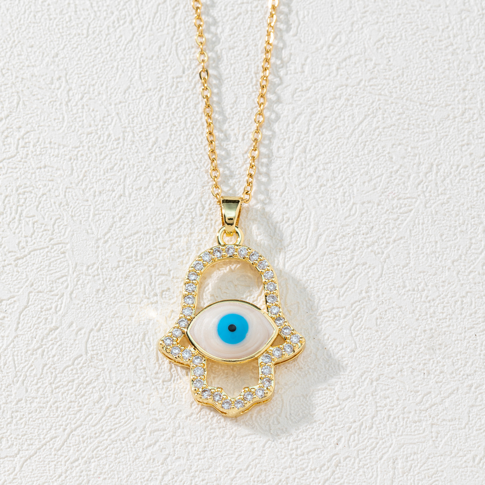 A new European and American fashion trend copper zircon Devil's eye palm necklace pendant with micro-inlaid electroplated real gold sweater chain Application Scenario