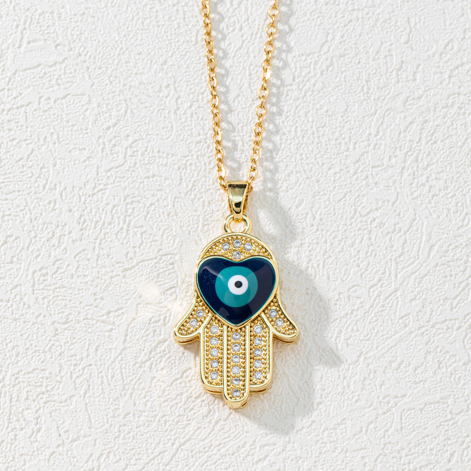 A new European and American fashion trend copper zircon Devil's eye palm necklace pendant with micro-inlaid electroplated real gold sweater chain details Picture