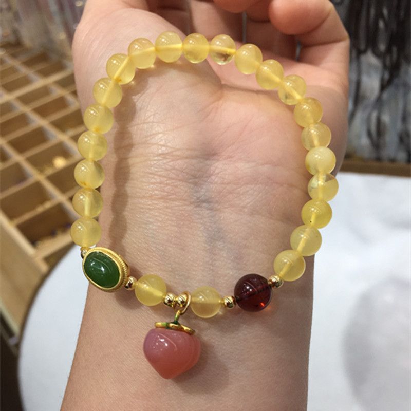 The bright crystal jewelry natural amber bracelet has a smooth and fine surface and is paired with a Hetian jade blood amber bracelet Application Scenario