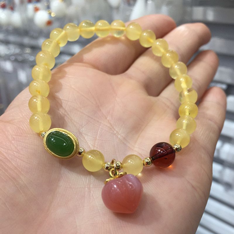 The bright crystal jewelry natural amber bracelet has a smooth and fine surface and is paired with a Hetian jade blood amber bracelet Specification image