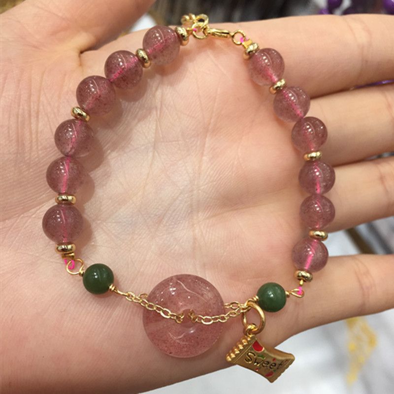 The natural strawberry crystal peace pendant bracelet is bright and colorful with abundant water content