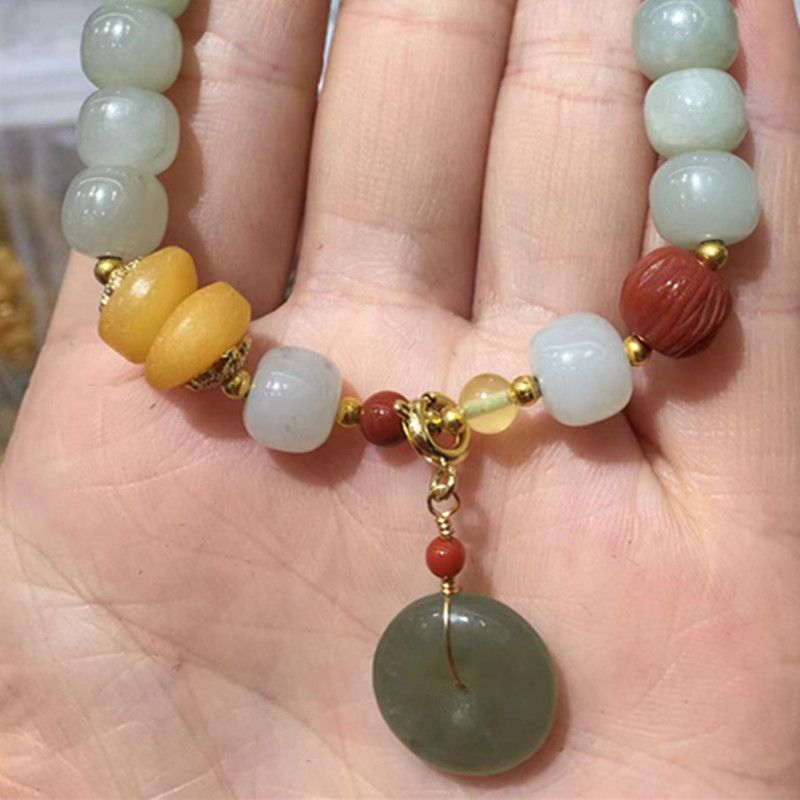 The natural Hetian jade peace pendant bracelet with bright crystal jewelry features vivid colors and abundant water content