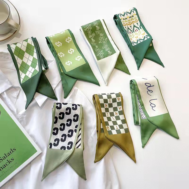 FLY1808 is a green silk scarf that makes women look fair and tender. It features a narrow ribbon-like headband for spring and summer, which can be used to tie hair and bags, as well as a long decorative scarf Application Scenario