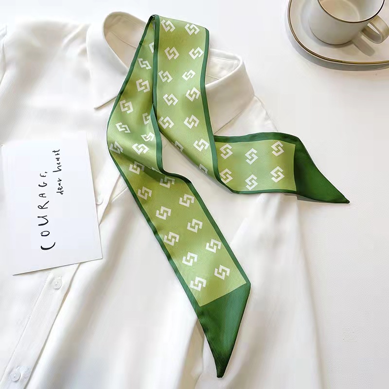 FLY1808 is a green silk scarf that makes women look fair and tender. It features a narrow ribbon-like headband for spring and summer, which can be used to tie hair and bags, as well as a long decorative scarf details Picture