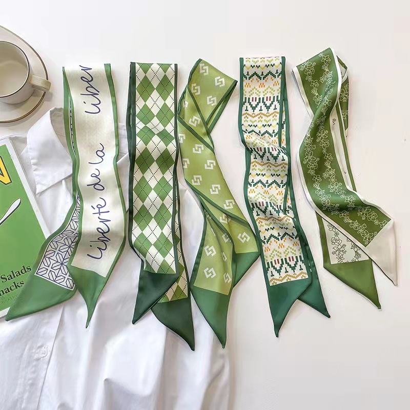 FLY1808 is a green silk scarf that makes women look fair and tender. It features a narrow ribbon-like headband for spring and summer, which can be used to tie hair and bags, as well as a long decorative scarf Specification image