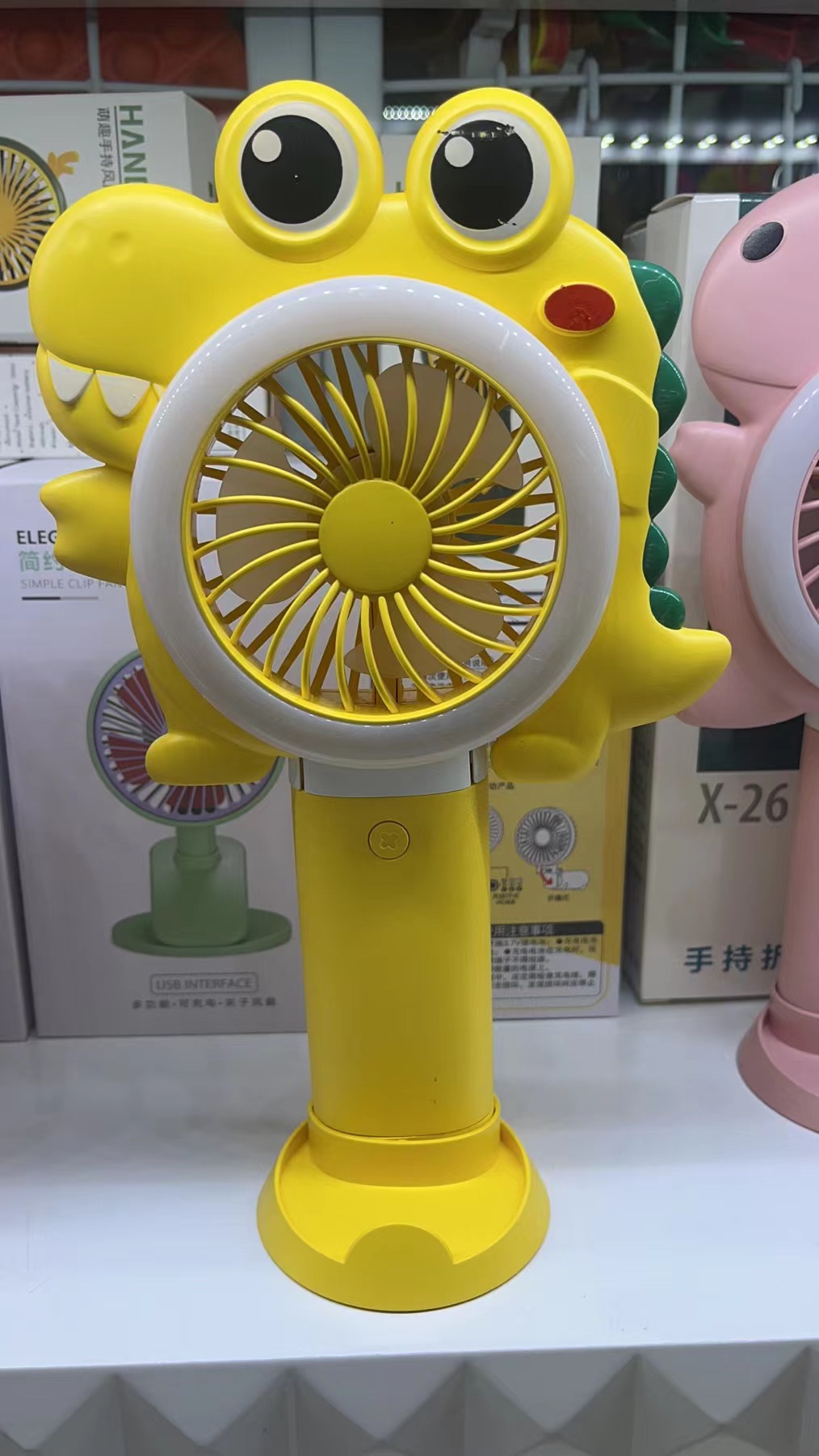 The X26 dual-color light folding fan comes in three colors: yellow, pink and green. It can be folded with three wind speeds and is convenient to carry by hand Item Picture