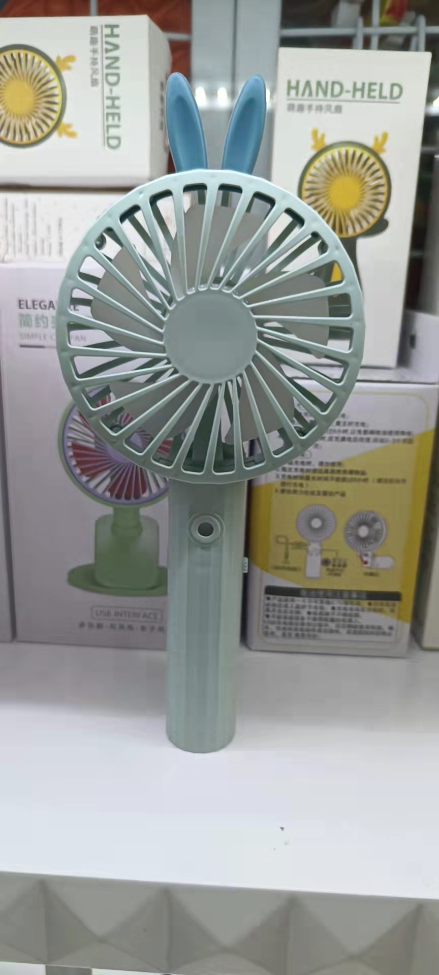 66-25 Spray charging fan in four colors: gray, pink, green and blue. It is a two-in-one handheld fan that can spray water Application Scenario